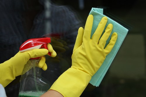 Cleaner in protective gloves preparing safe cleaning equipment
